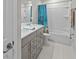 Beautiful bathroom boasts a double vanity, white shower and tile floors at 19259 Mossy Pine Dr, Tampa, FL 33647