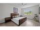 Serene bedroom showcasing a wood-framed bed, neutral decor, a large window, and plank floors at 19259 Mossy Pine Dr, Tampa, FL 33647