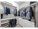 Organized walk-in closet offering ample hanging space, shelving, and drawers for efficient storage at 19259 Mossy Pine Dr, Tampa, FL 33647
