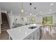 Spacious kitchen with an island, dining area, and views of the living room and the staircase at 19259 Mossy Pine Dr, Tampa, FL 33647