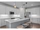 Modern kitchen featuring white cabinetry, stainless steel appliances, a center island and stylish pendant lights at 19259 Mossy Pine Dr, Tampa, FL 33647