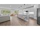 Bright, open-concept living space with modern kitchen island, dining area, and comfortable living room at 19259 Mossy Pine Dr, Tampa, FL 33647