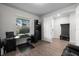 Functional home office with a desk, storage shelves, and a view to the outdoors at 19259 Mossy Pine Dr, Tampa, FL 33647