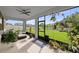 Covered lanai overlooking the lawn offers seating and a ceiling fan at 19259 Mossy Pine Dr, Tampa, FL 33647
