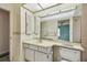 The bathroom features a sink, toilet, and a large vanity mirror at 1972 Lansing Dr, Clearwater, FL 33763