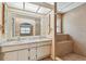 Bathroom vanity with double sinks, tile floor and a shower with a seat at 1972 Lansing Dr, Clearwater, FL 33763