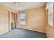 A carpeted bedroom with a ceiling fan and window with blinds at 1972 Lansing Dr, Clearwater, FL 33763