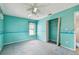 A carpeted bedroom with a ceiling fan and window with blinds at 1972 Lansing Dr, Clearwater, FL 33763