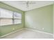 Bedroom featuring a ceiling fan, a window and neutral paint, providing comfort and natural light at 1972 Lansing Dr, Clearwater, FL 33763