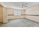 Light bedroom with a ceiling fan, window, and neutral walls at 1972 Lansing Dr, Clearwater, FL 33763