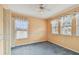 A bedroom featuring two windows with blinds and a ceiling fan at 1972 Lansing Dr, Clearwater, FL 33763