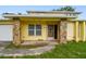 Inviting front porch with stone pillars and a traditional front door at 1972 Lansing Dr, Clearwater, FL 33763
