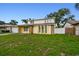 Well-maintained front yard of a two-story home with ample parking at 1972 Lansing Dr, Clearwater, FL 33763
