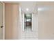 Hallway with access to kitchen featuring tile flooring at 1972 Lansing Dr, Clearwater, FL 33763
