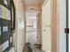 Hallway leading to a carpeted bedroom with a window at 1972 Lansing Dr, Clearwater, FL 33763