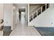 Hallway view shows the tiled floor and staircase that lead to the upper level at 1972 Lansing Dr, Clearwater, FL 33763