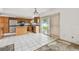 Bright kitchen featuring wood cabinets, stainless steel appliances, tile flooring, and sliding glass doors to the backyard at 1972 Lansing Dr, Clearwater, FL 33763