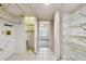 Laundry room features shelving units and access to another room at 1972 Lansing Dr, Clearwater, FL 33763