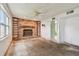 Living room with a stone fireplace and a ceiling fan at 1972 Lansing Dr, Clearwater, FL 33763