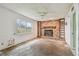 Living room with a stone fireplace and shelves, next to a window at 1972 Lansing Dr, Clearwater, FL 33763