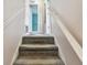 Carpeted staircase in a well-lit hallway, providing safe and easy access to upper floors at 1972 Lansing Dr, Clearwater, FL 33763