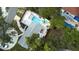 Overhead shot of a home showcasing a swimming pool, patio with lounge chairs, and a cozy fire pit area at 201 South St, Palm Harbor, FL 34683