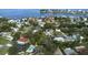 Aerial view of a house with a pool and patio near the water, with houses nearby at 201 South St, Palm Harbor, FL 34683