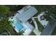 Aerial view of a house with a pool, patio with lounge chairs, and a fire pit area in a well-kept backyard at 201 South St, Palm Harbor, FL 34683
