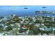 Aerial view of a property near the water, including a pool and patio, with the Dunedin Causeway visible in the background at 201 South St, Palm Harbor, FL 34683