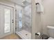 Beautiful bathroom featuring glass enclosed shower, tile surround and floor, and bright white accents at 201 South St, Palm Harbor, FL 34683