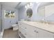 Bathroom with double sink vanity, white cabinets, and a glass enclosed shower at 201 South St, Palm Harbor, FL 34683