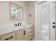 Modern bathroom featuring new vanity, modern black faucet and hardware, a framed mirror, and access to the exterior at 201 South St, Palm Harbor, FL 34683
