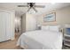 Bedroom featuring hardwood floors, neutral walls, ensuite access, and comfortable bedding at 201 South St, Palm Harbor, FL 34683