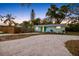 Charming single story home with a well kept lawn, wooden fence, and inviting landscaping at 201 South St, Palm Harbor, FL 34683