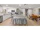 Bright modern kitchen featuring stainless steel appliances, quartz countertops, and an island with seating at 201 South St, Palm Harbor, FL 34683