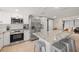 Bright modern kitchen featuring stainless steel appliances, quartz countertops, and a central island at 201 South St, Palm Harbor, FL 34683