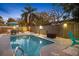 Charming outdoor pool area with mature landscaping, dining area, perimeter fence and cozy seating at 201 South St, Palm Harbor, FL 34683
