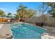 Relaxing pool area featuring refreshing pool, sun loungers, dining and wooden perimeter fence at 201 South St, Palm Harbor, FL 34683