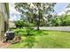Expansive backyard with lush lawn, mature trees, and a privacy fence creating a serene outdoor space at 2119 Broadway View Ave, Brandon, FL 33510