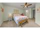 Comfortable bedroom with neutral tones, ceiling fan, and a decorative wooden bench at 2119 Broadway View Ave, Brandon, FL 33510