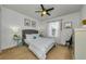 Stylish bedroom featuring a gray upholstered bed, ceiling fan, and bright natural light at 2119 Broadway View Ave, Brandon, FL 33510