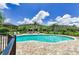 Community pool surrounded by well-maintained landscaping, lounge chairs, and clear blue water at 2119 Broadway View Ave, Brandon, FL 33510