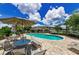 Community pool with lounge seating and umbrellas offers a refreshing oasis for relaxation and socializing at 2119 Broadway View Ave, Brandon, FL 33510