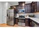 Spacious kitchen featuring sleek stainless steel appliances and dark wood cabinetry at 2119 Broadway View Ave, Brandon, FL 33510