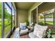 Inviting screened-in lanai with comfortable seating and views of the lush backyard at 2119 Broadway View Ave, Brandon, FL 33510