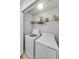 Convenient laundry room featuring a washer, dryer, and shelving for storage solutions at 2119 Broadway View Ave, Brandon, FL 33510