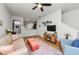 Open-concept living room flows into kitchen area with light-colored walls, wood flooring, and ceiling fan at 2119 Broadway View Ave, Brandon, FL 33510