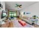 Bright living room features a ceiling fan, neutral tones, and a sliding glass door to the backyard at 2119 Broadway View Ave, Brandon, FL 33510