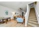 Inviting living room features wood flooring, light walls, a ceiling fan, and stair access at 2119 Broadway View Ave, Brandon, FL 33510