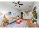 Bright living room has wood floors, a ceiling fan, and a view into the kitchen area at 2119 Broadway View Ave, Brandon, FL 33510